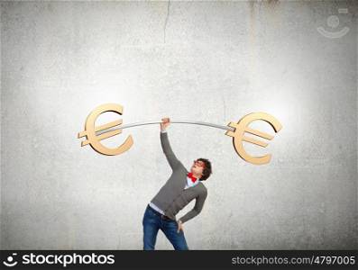 Euro currency concept. Young strong man lifting barbell with euro signs