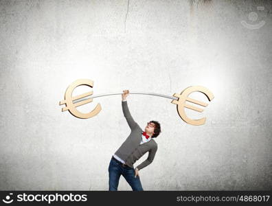 Euro currency concept. Young strong man lifting barbell with euro signs