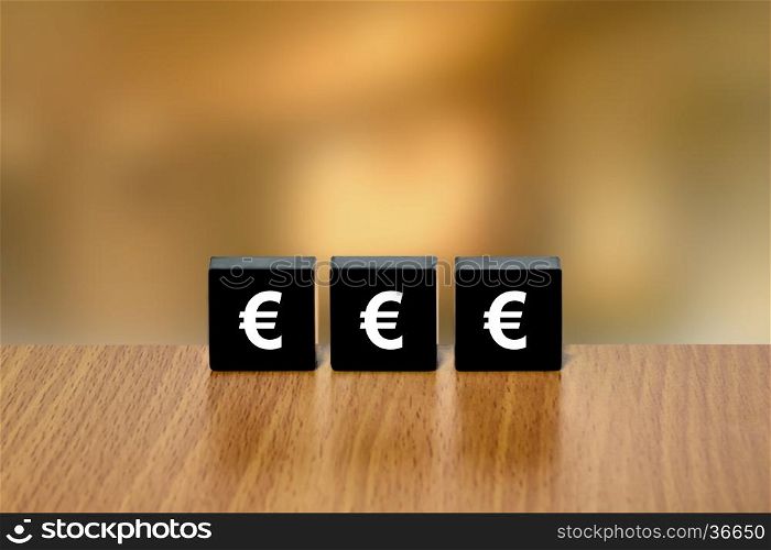 euro currency on black block with blurred background