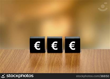 euro currency on black block with blurred background