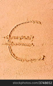 euro currency symbol is drawn on wet sand on the beach