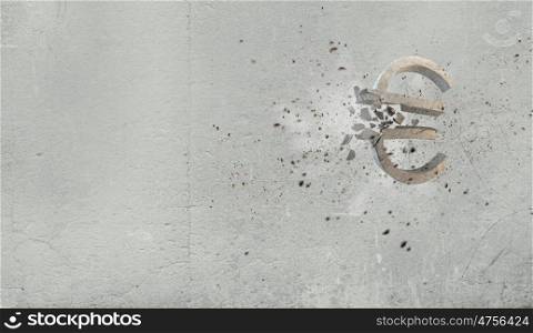 Euro fall. Conceptual image with stone broken euro sign