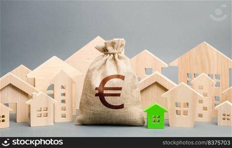 Euro money bag and a city of house figures. Buying real estate, fair price. City municipal budget. Property tax. Development and renovation of buildings. Investments. Cost of living in town.