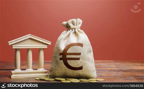 Euro money bag and bank / government building. Tax collection and budgeting. State debt. GDP and GNP. Monetary policy. Support businesses in times of crisis. Lending loans, placing deposits.