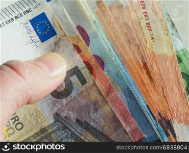 Euro notes, European Union. Hand holding Euro banknotes money (EUR), currency of European Union