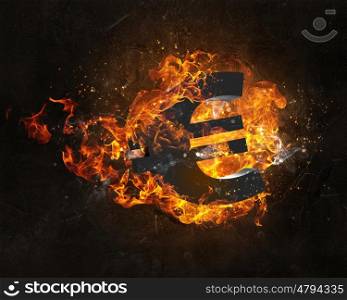 Euro symbol in fire. Euro currency sign burning in fire flames on dark background