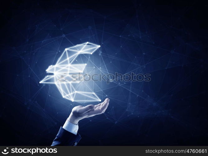 Euro symbol in palm. Hand of businessman holding euro glowing sign on dark background