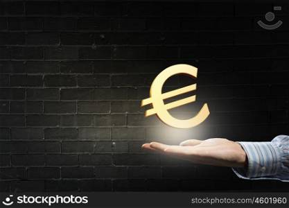 Euro symbol in palm. Hand of businessman holding euro sign in palm