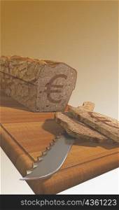 Euro symbol on a loaf of bread with a knife on a cutting board