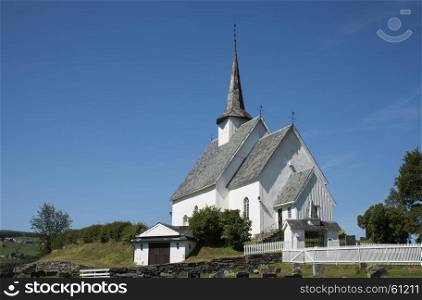 Europe Norway Ulnes church along lakeshore in central Norway