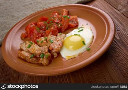 European breakfast - egg, bacon and tomato.