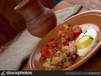 European breakfast - egg, bacon and tomato.