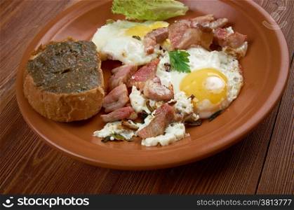 European country breakfast - fried eggs, fried bacon and baguette with aubergine pasting