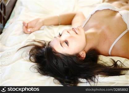 european fashion model posing in bed wearing white underwear