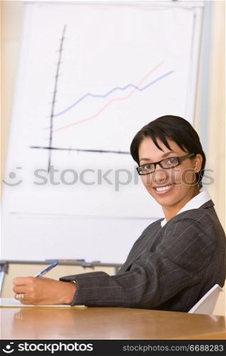 european female in office in front of flip chart