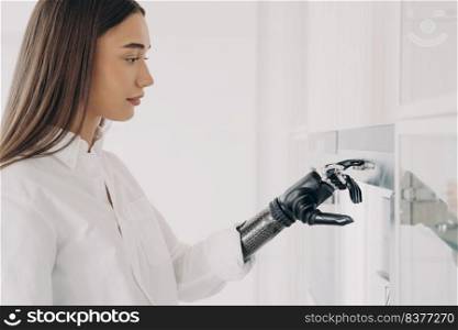 European handicapped woman is cooking. Robotic cyber hand is switching oven on at kitchen. Amputee is using high technology futuristic bionic prosthesis. Software in fingers and wrist joint.. European handicapped woman is cooking. Robotic cyber hand is switching oven on at kitchen.