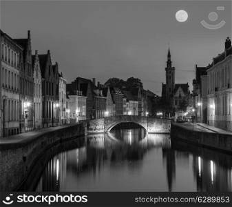 European medieval night city view background - Bruges Brugge canal in the evening, Belgium. Black and white version