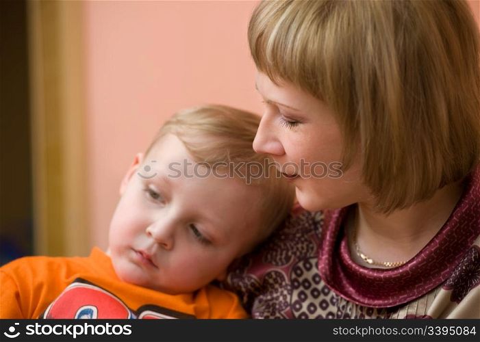 european woman looks lovingly at her little son, focus on the mother
