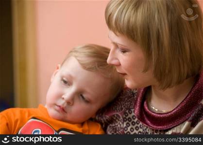 european woman looks lovingly at her little son, focus on the mother