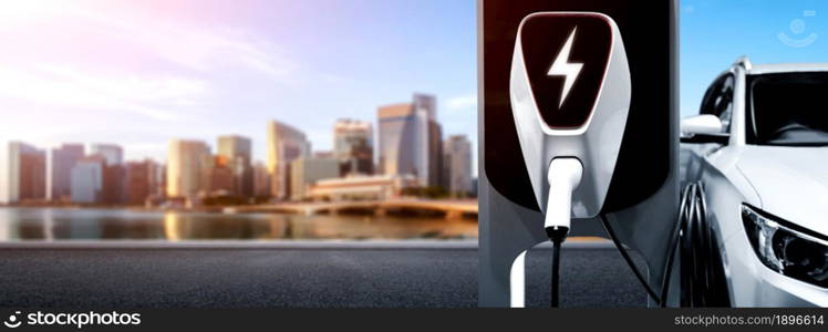 EV charging station for electric car in concept of green energy and eco power produced from sustainable source to supply to charger station in order to reduce CO2 emission .. EV charging station for electric car in concept of green energy and eco power