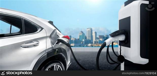 EV charging station for electric car in concept of green energy and eco power produced from sustainable source to supply to charger station in order to reduce CO2 emission .. EV charging station for electric car in concept of green energy and eco power
