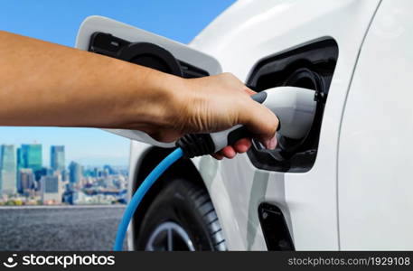 EV charging station for electric car in concept of green energy and eco power produced from sustainable source to supply to charger station in order to reduce CO2 emission .. EV charging station for electric car in concept of green energy and eco power