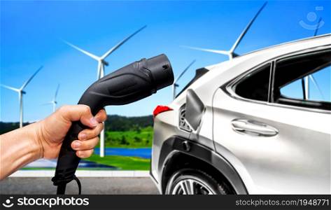 EV charging station for electric car in concept of green sustainable energy produced from renewable resources to supply to charger station in order to reduce CO2 emission .. EV charging station for electric car in concept of green sustainable energy