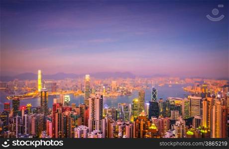Evening aerial view panorama of Hong Kong skyline and Victoria Harbor. Travel destinations. Tilt shift effect