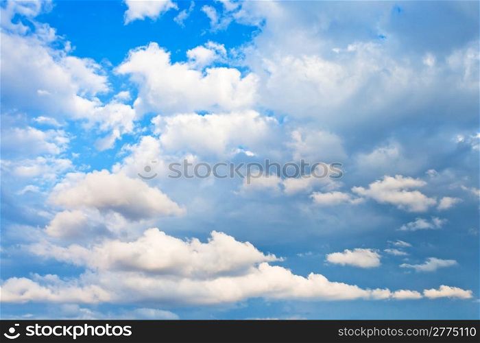 evening cumulus clouds in blue summer sky