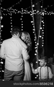 evening dances of the newlyweds against the backdrop of warm lights