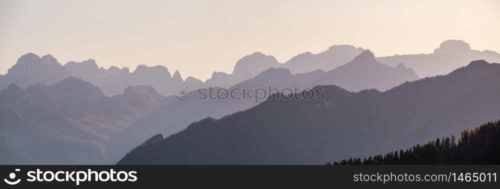 Evening Dolomite mountain tops silhouettes peaceful view from Giau Pass, Italy. Climate, environment and travel concept scene.