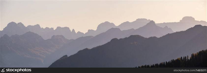 Evening Dolomite mountain tops silhouettes peaceful view from Giau Pass, Italy. Climate, environment and travel concept scene.