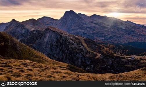 Evening dusk autumn alpine Dolomites mountain panoramic view from Baita Segantini, Rolle Pass, Trento, Italy. Picturesque traveling, seasonal, nature and countryside beauty concept scene.