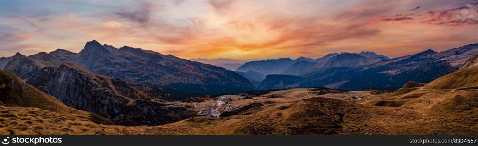 Evening dusk autumn alpine Dolomites mountain panoramic view from Baita Segantini, Rolle Pass, Trento, Italy. Picturesque traveling, seasonal, nature and countryside beauty concept scene.