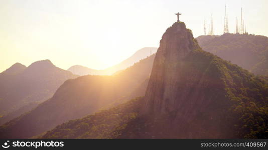 evening hills with statue of Jesus at Rio de Janeiro abstract shot at sunset time, Brazil