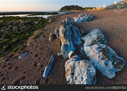Evening ocean coast view from beach with big stones (near Saint-Jean-de-Luz, France, Bay of Biscay).