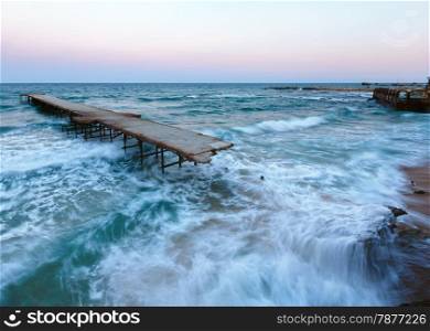 Evening sea storm and ruined pier (Black Sea, Bulgaria).