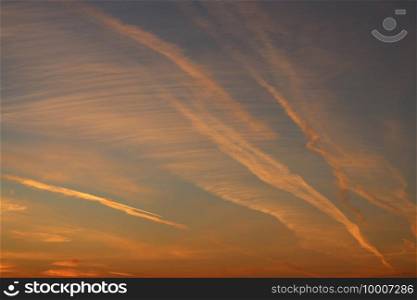 evening sky with red clouds, airplane trails