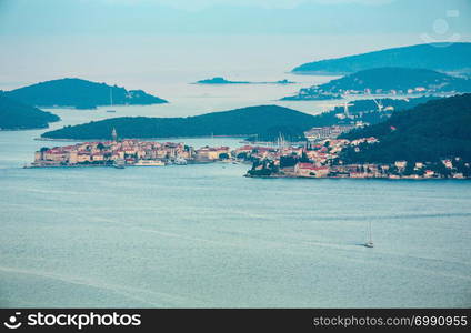 Evening summer coastline, Croatian islands and Korcula Town on seashore (view from Peljesac peninsula, Croatia).