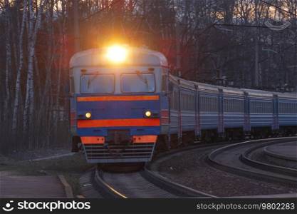 evening train rides on the railroad among the forest