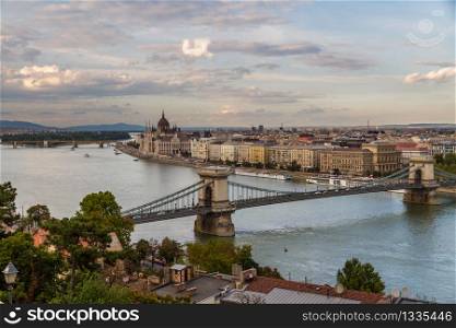 Evening view of river danube, chain bridge and Hungarian Parliament Building, Budapest, Hungary, landscape, clouds in sky.