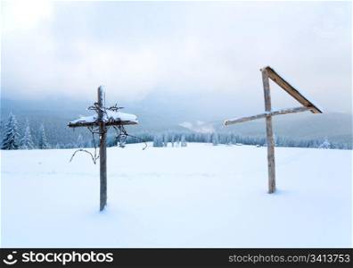 Evening winter calm mountain landscape with wooden cross in front (Kukol Mount, Carpathian Mountains, Ukraine)
