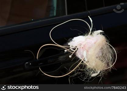 Event details. Closeup of wedding car decorated with beautiful pink flowers roses