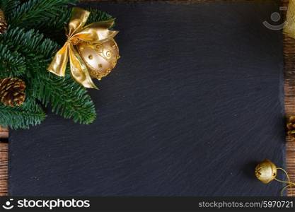 evergreen tree with golden ball. evergreen tree with golden ball and bell christmas frame on black background