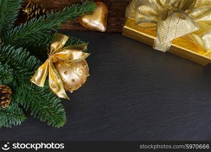 evergreen tree with golden decorations . evergreen tree with golden ball and gift box christmas frame on black background