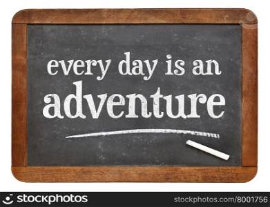 Every day is an adventure - positive attitude words on a vintage slate blackboard