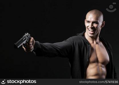 evil smiling man shooting gun isolated on black background