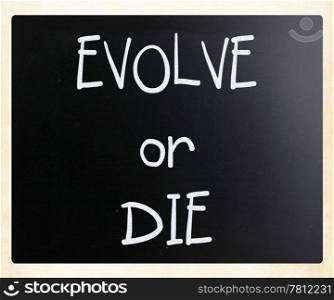 ""Evolve or Die" handwritten with white chalk on a blackboard"