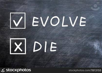 Evolve or die with check boxes drawn with chalk on a smudged blackboard