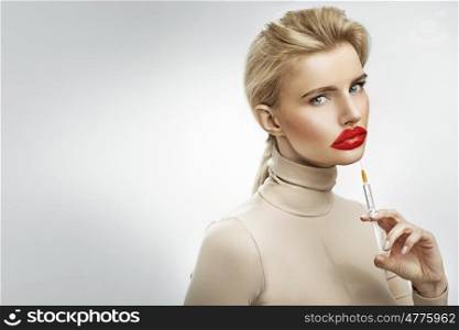Exaggerated injection to the lips of a beautiful blond lady